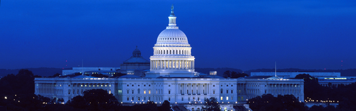 Image of the United State Congressional building lit in the early evening.